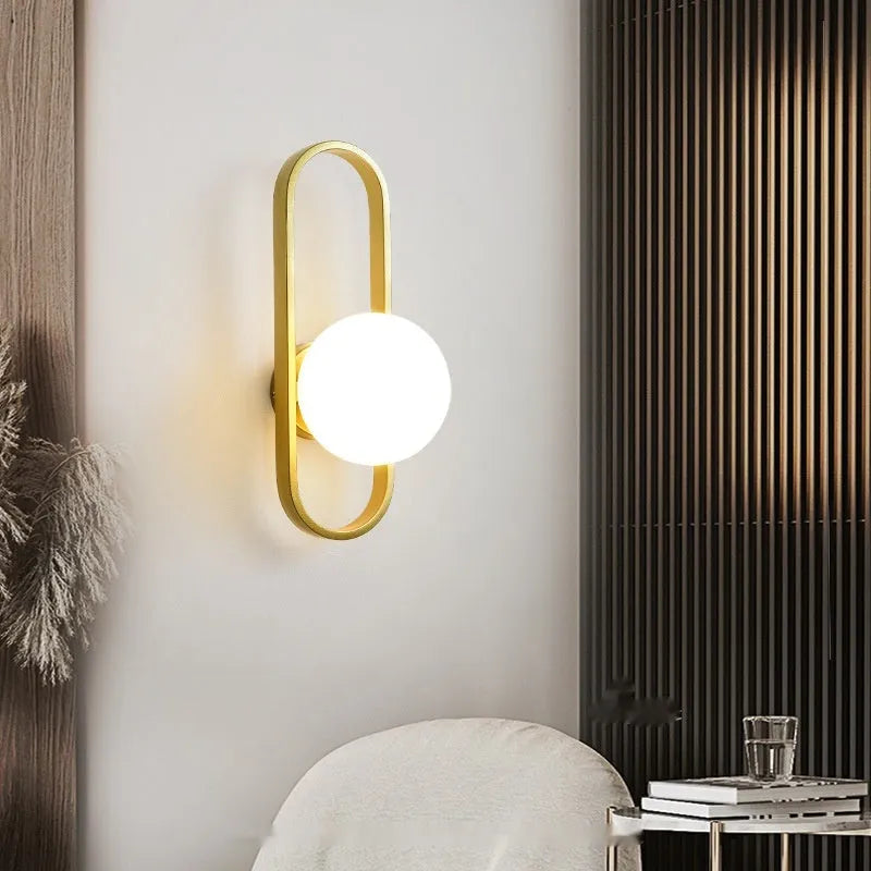 Minimalist wall lamp with glass shade and iron body in black finish mounted on wall