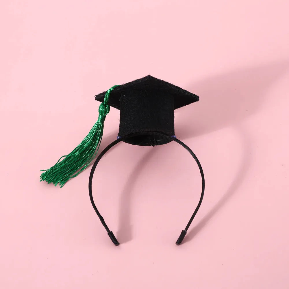 Small pet wearing an elastic wool felt hair band and matching doctor's degree bow tie.