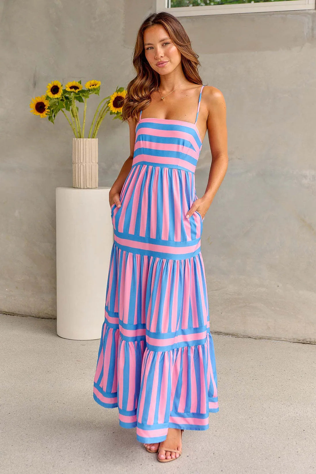 Women's striped long summer dress with suspenders, a square neck, backless design, and side pockets.