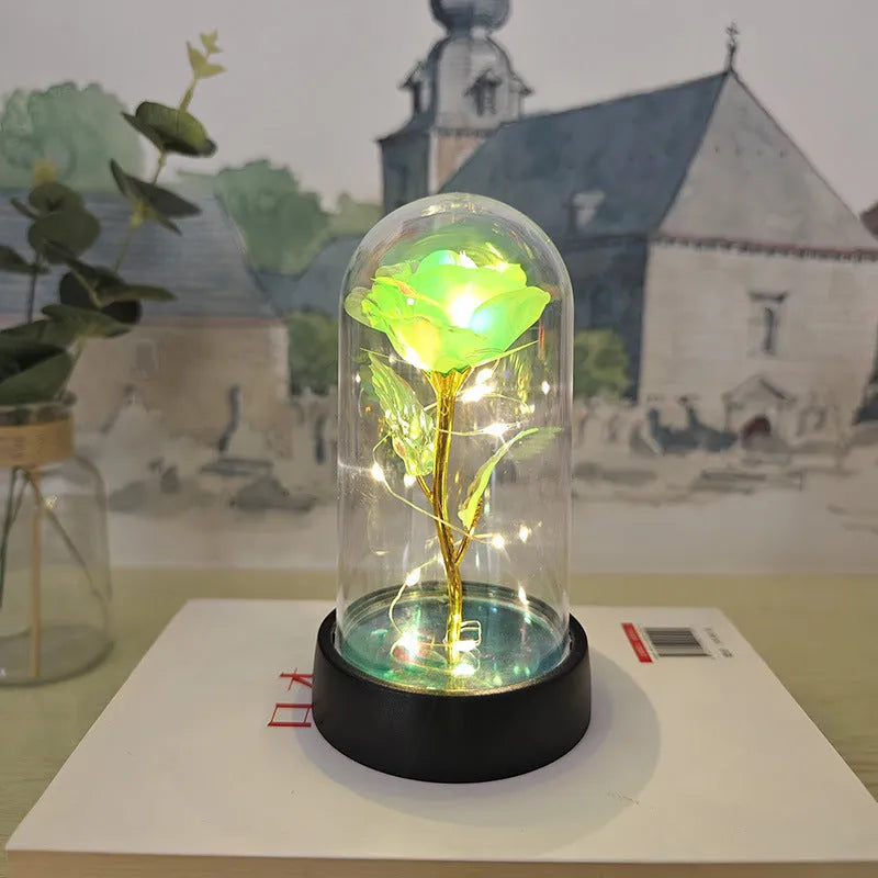 Small plastic night lamp with glass cover and flower decoration on black base