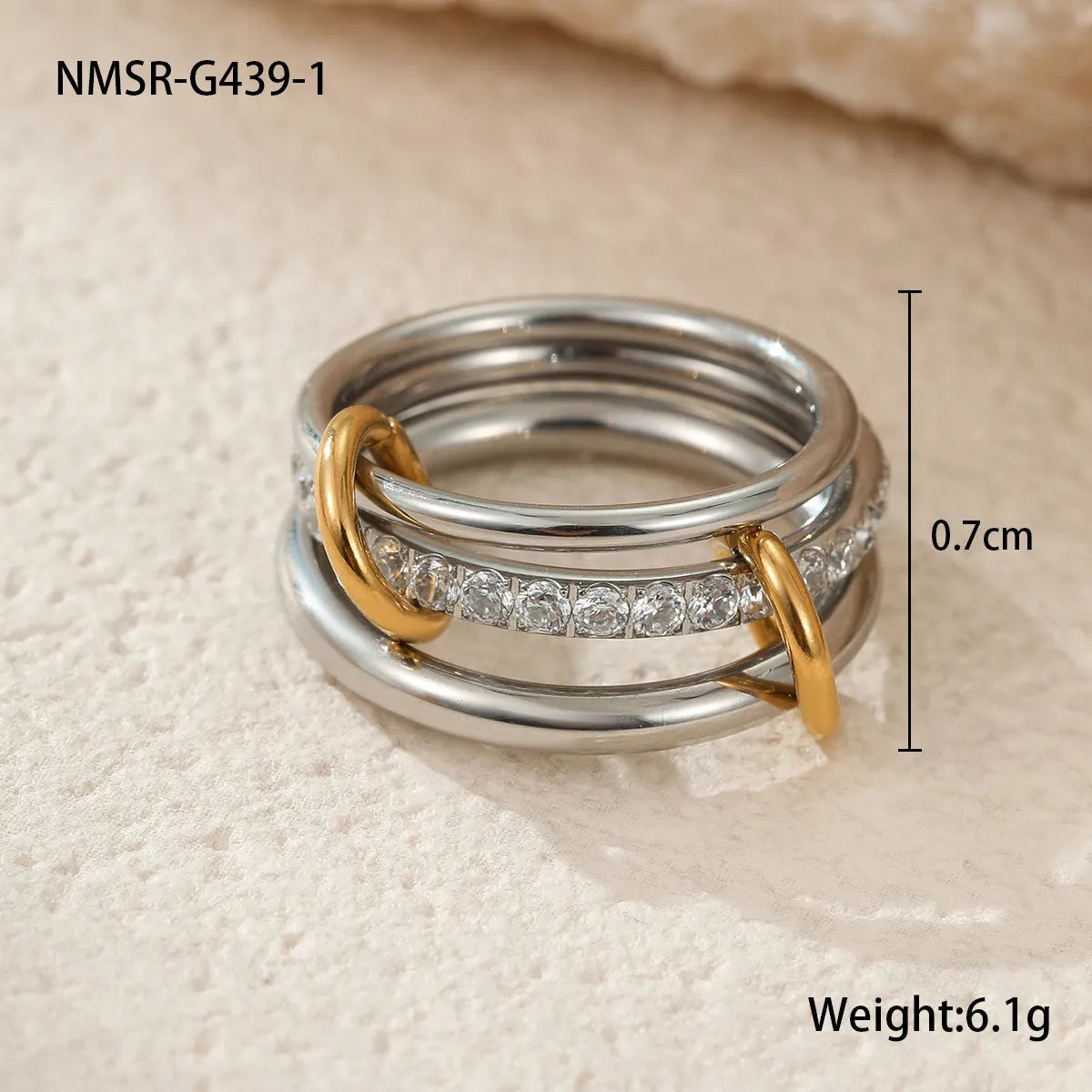 Stacked gold plated stainless steel ring set with exaggerated design on hand