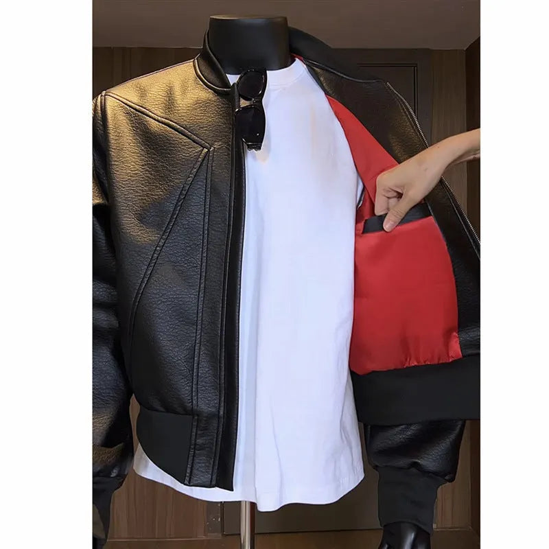 Man modelling a slim-fit black PU leather jacket with litchi grain texture and extended length.