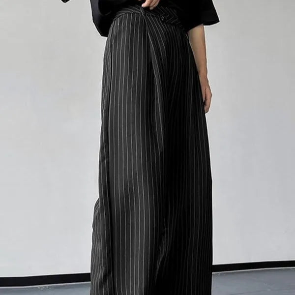 Black men's trousers with vertical stripes and pleats, made from an elastic rabbit hair and bamboo fibre blend.