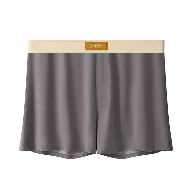 Pack of three men's solid colour loose fit ice silk underwear briefs on a grey background.