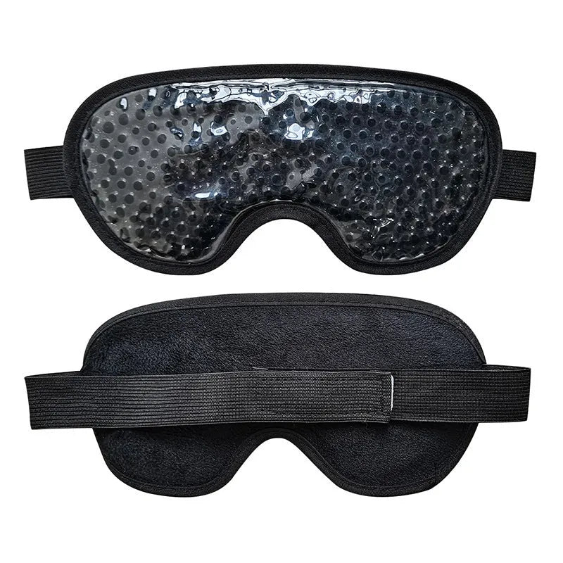 White portable rechargeable warm eye compress device and eye mask set on a table.