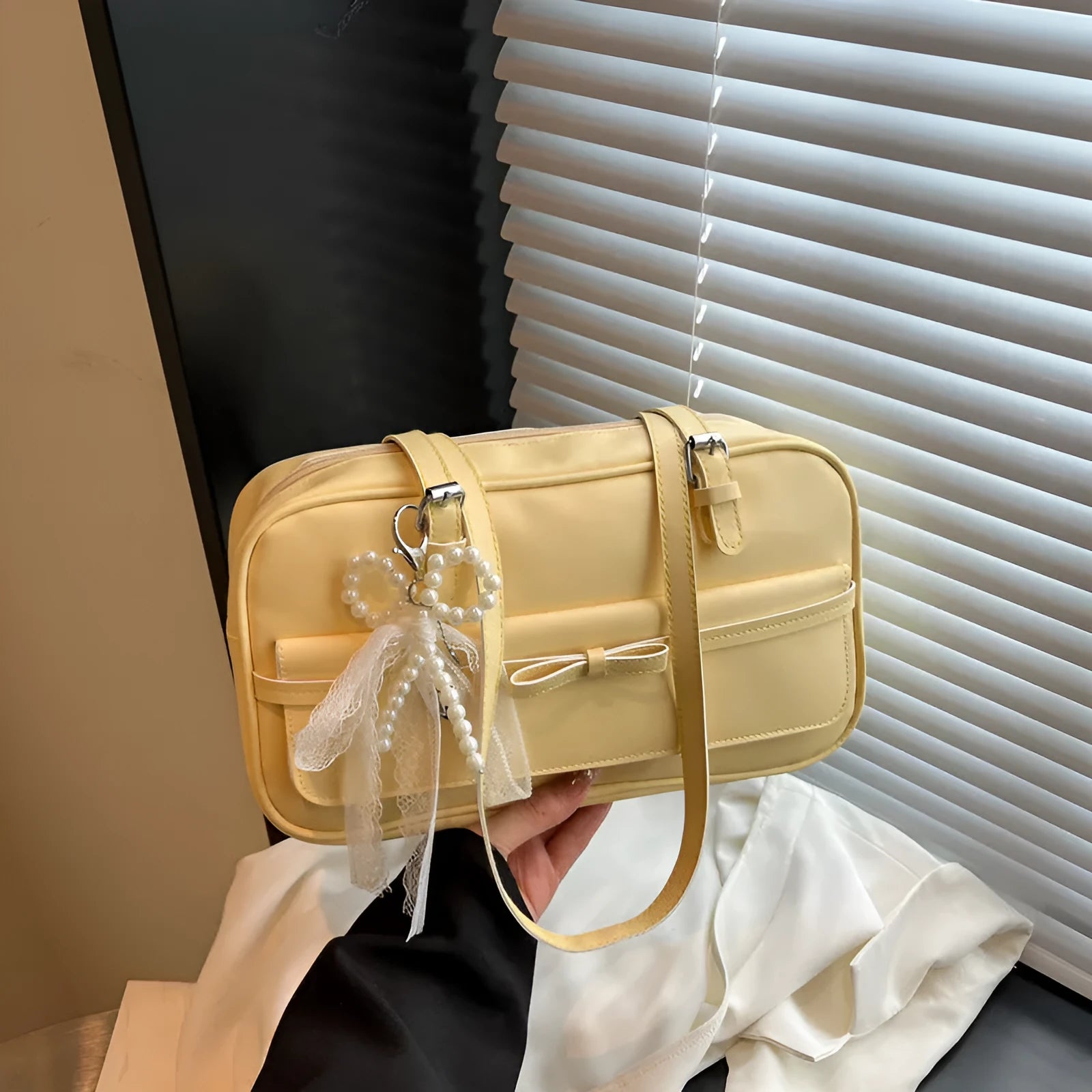 Women's black PU leather single shoulder flap bag with horizontal square shape and bow detail