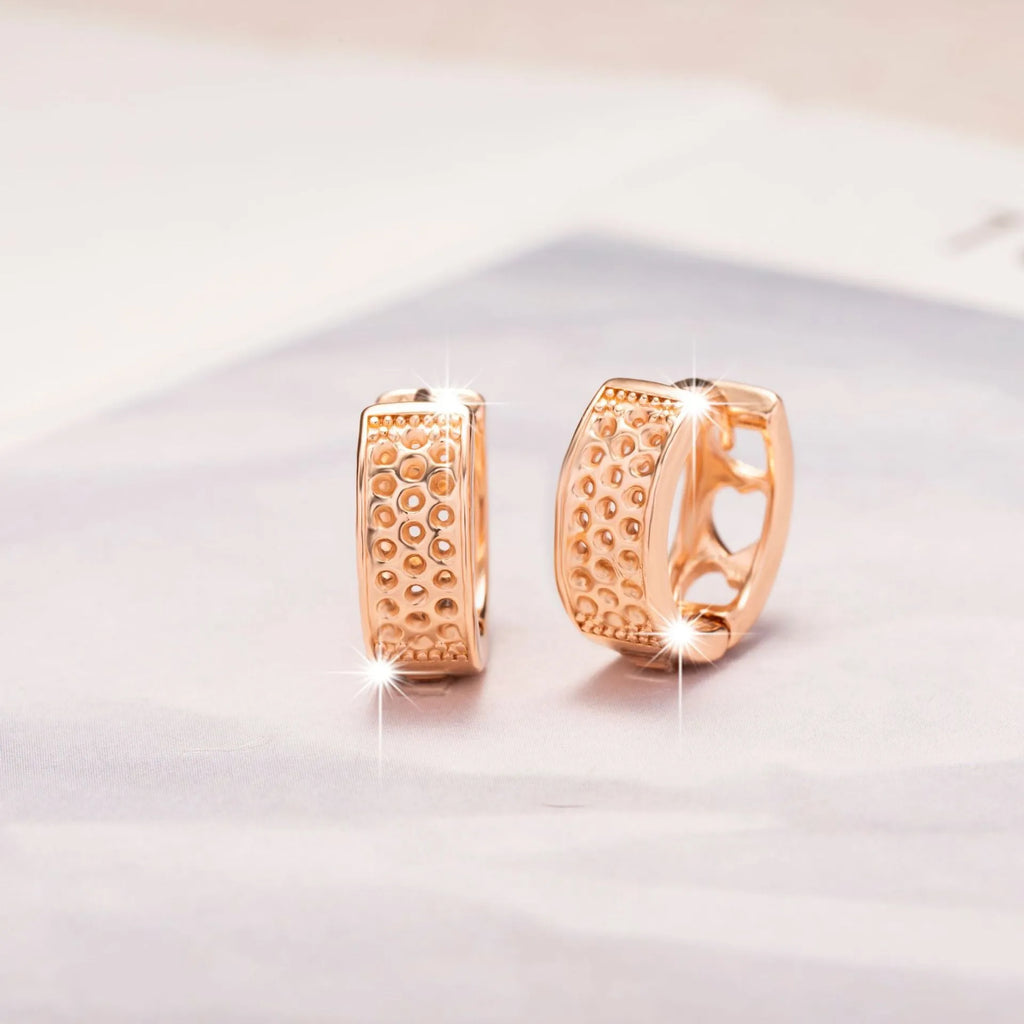 Rose gold women's earrings with a hollow heart shape and circular silhouette.