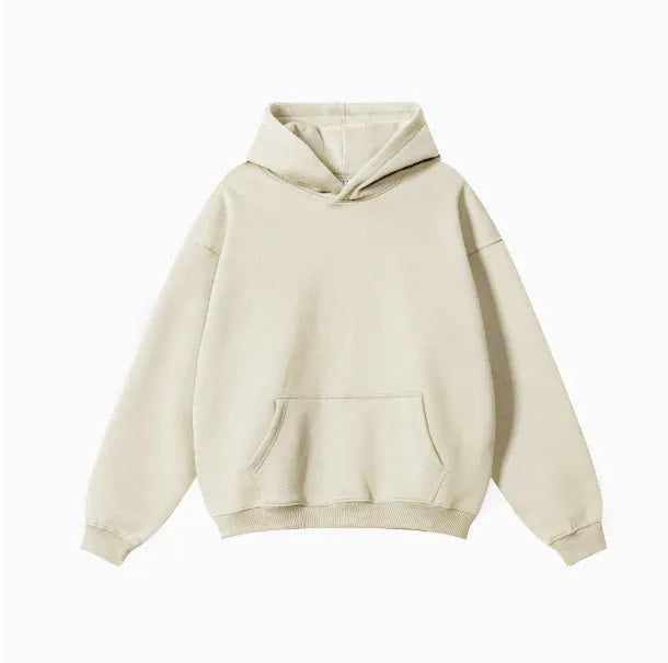 Man wearing a loose-fit grey cotton hooded sweater with drop-shoulder sleeves.