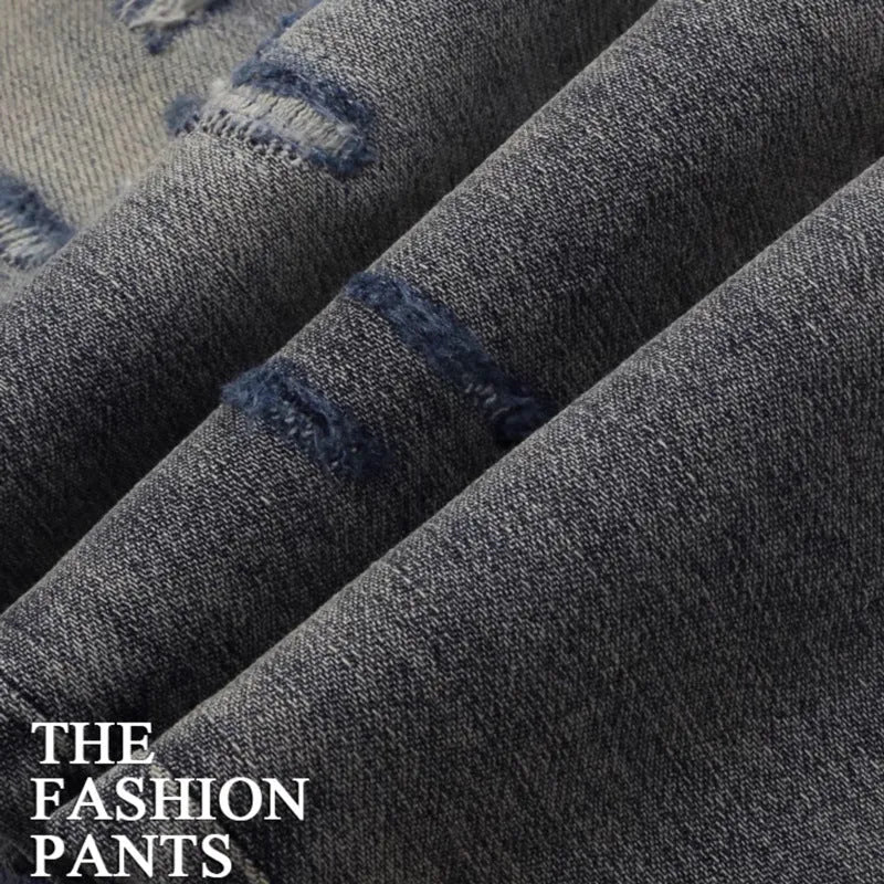 Men's slim fit old colour jeans with hole patch detail and embroidered branding on the leg