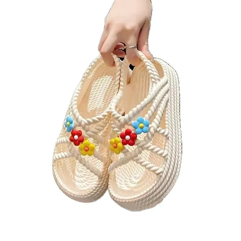 Beige women's flat sandals with a three-flower decoration and a non-slip PVC sole.