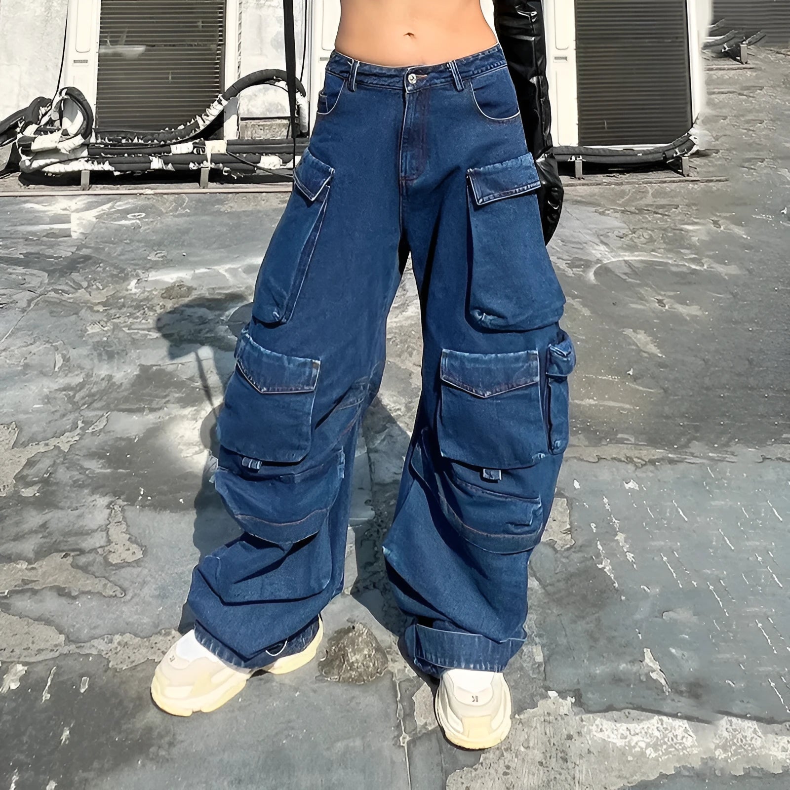 Dark blue distressed wide-leg jeans with a high waist and multiple pockets on a model.