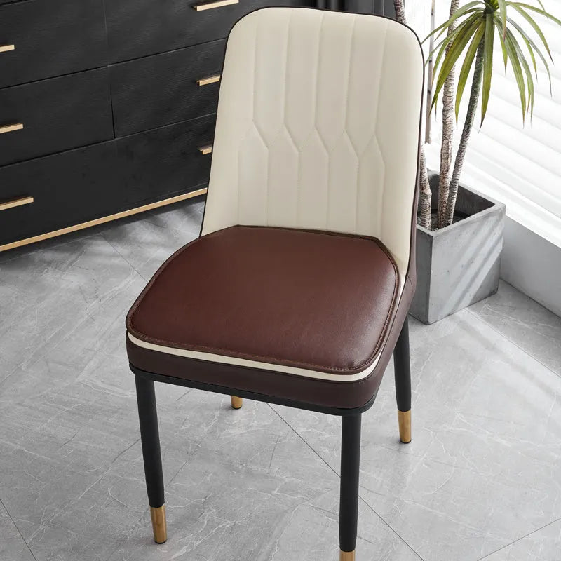 Leather horseshoe-shaped non-slip seat cushion in a solid colour on a chair.
