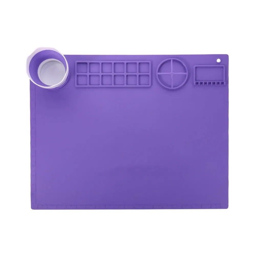 Light blue silicone painting mat with two round bowl compartments, measuring 50 by 40 cm.