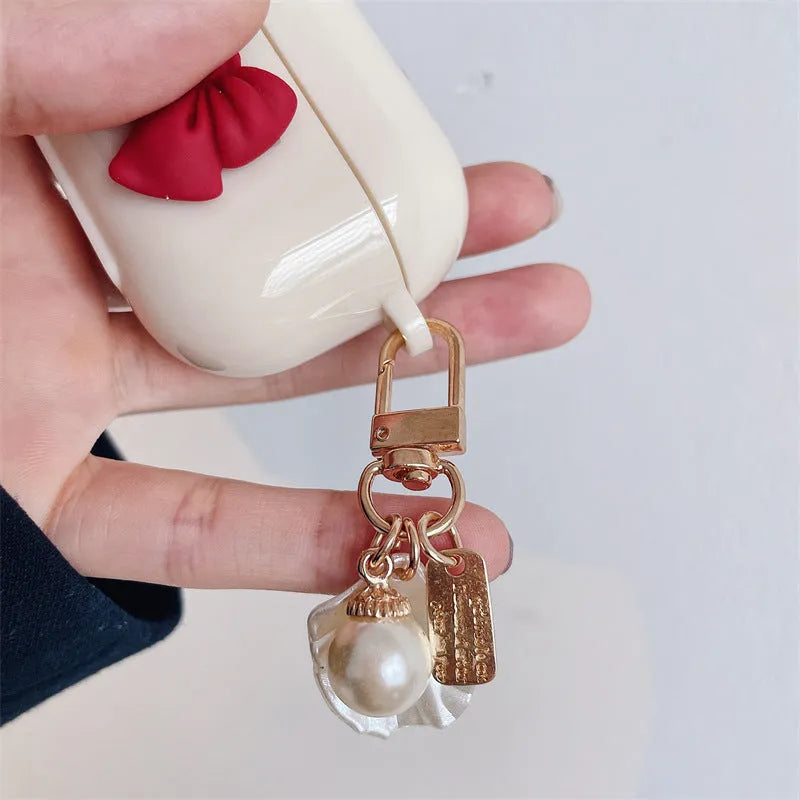 Beige red bow shell TPU AirPods protective case showing clamshell design