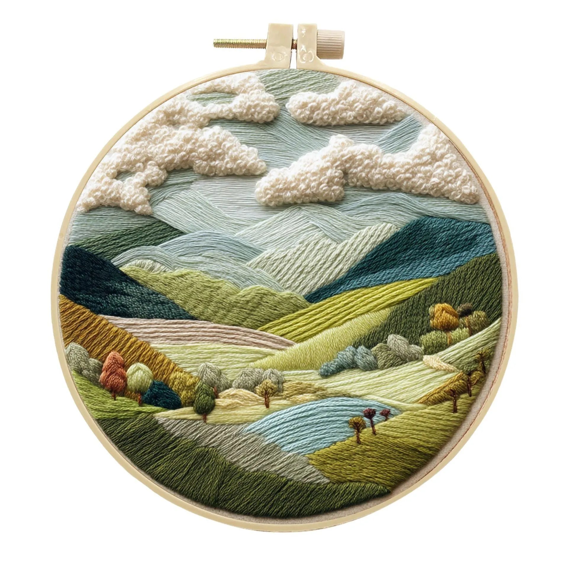 DIY embroidery kit with landscape-printed cotton fabric, embroidery hoop, needles, and coloured thread spools.