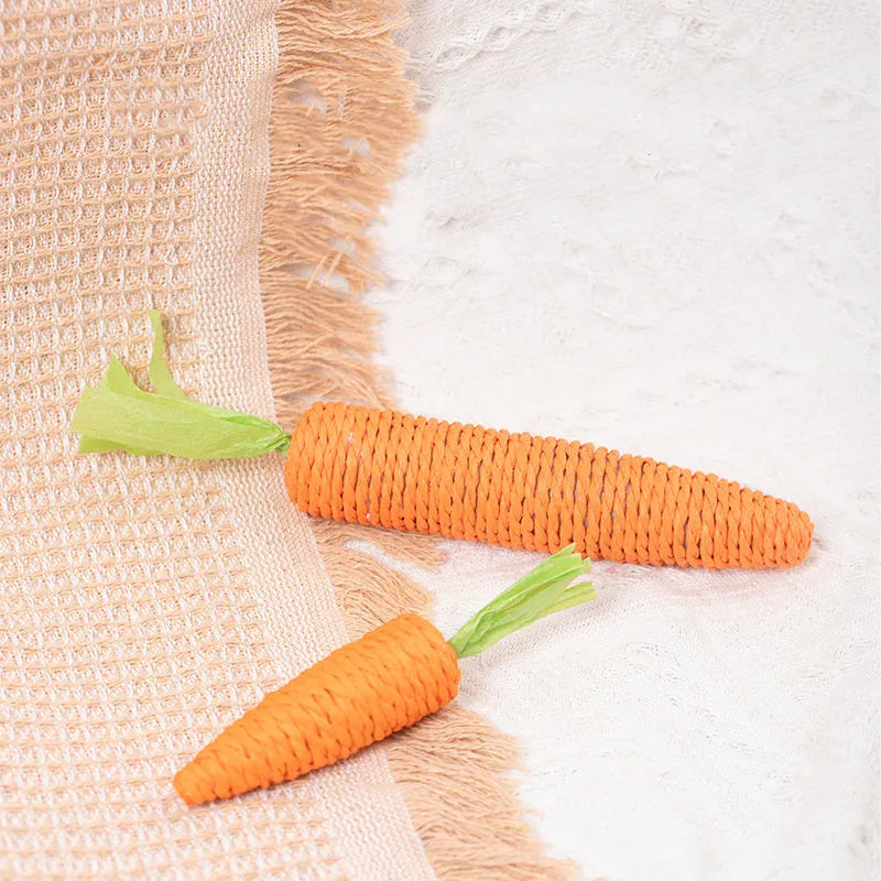 Set of cat toys including carrot-shaped bites, paper toys, ringing stones, and grinding sticks in two sizes.