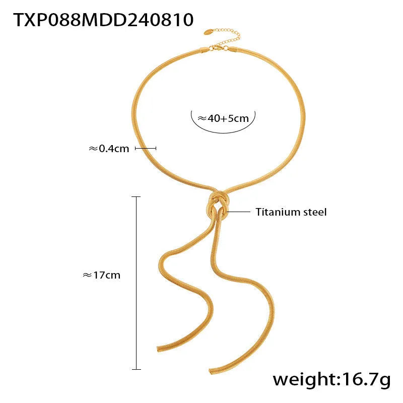Gold titanium steel long necklace with knotted tassel pendant and matching earrings on a white background.