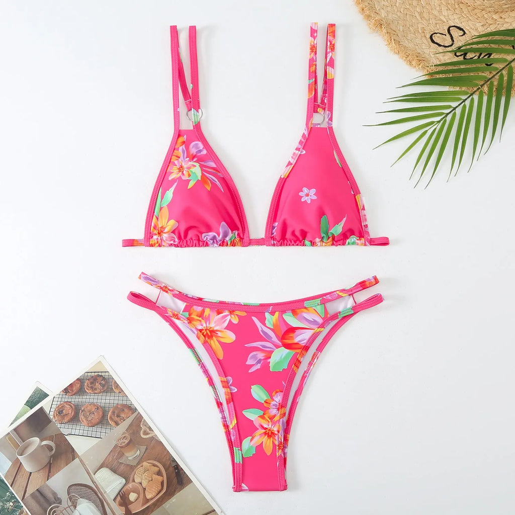 Women's printed halterneck bikini set in blue with floral pattern, showing top and briefs.