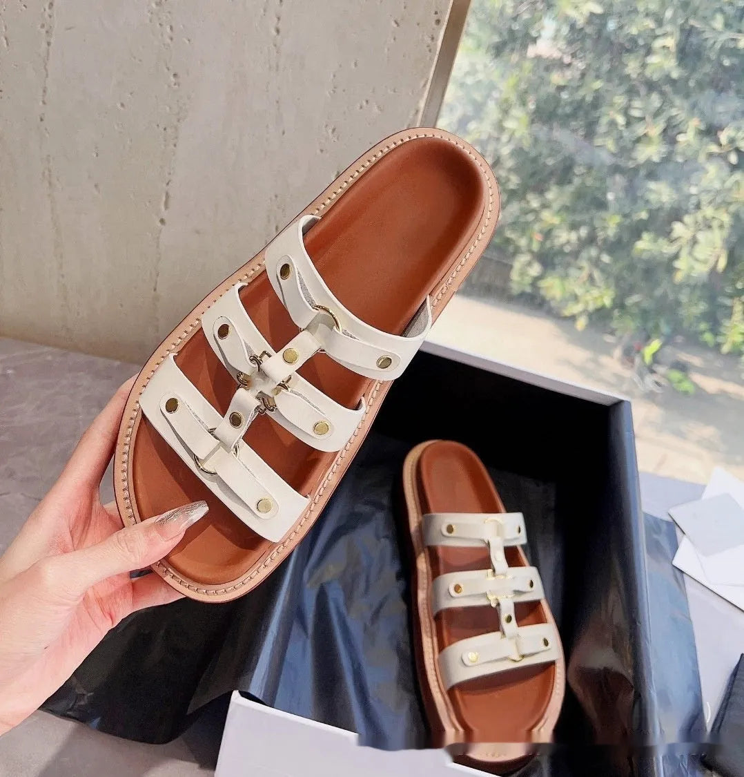 Women's white patent leather Roman sandal slippers with sheepskin lining shown from the side.