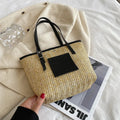 Straw woven women's shoulder bag in black showing European retro style with three-dimensional pocket