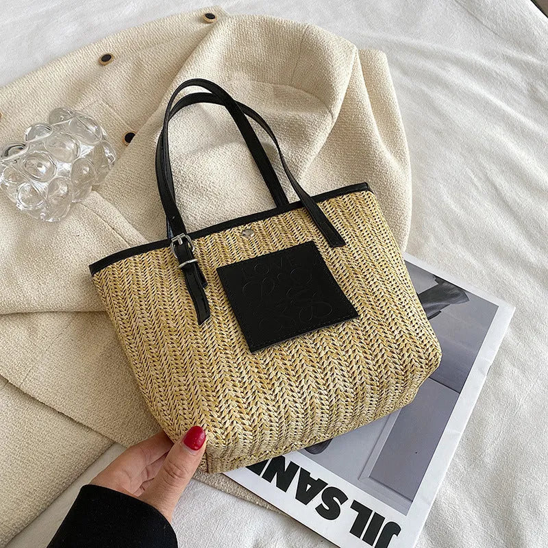 Straw woven women's shoulder bag in black showing European retro style with three-dimensional pocket