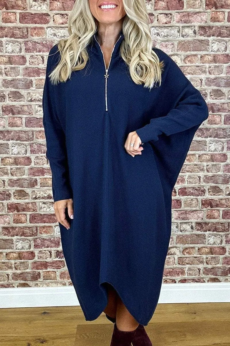 Women's solid colour loose fit knitted dress with raglan sleeves on a model.
