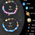 Two adjustable natural stone beaded bracelets with metal zodiac sign charms on a wooden surface.