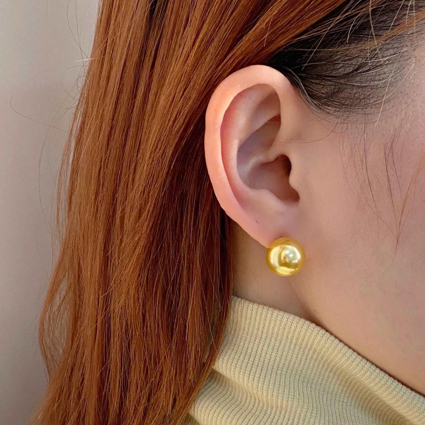 Women's large pearl stud earrings with an eight-pointed star geometric setting in sterling silver.