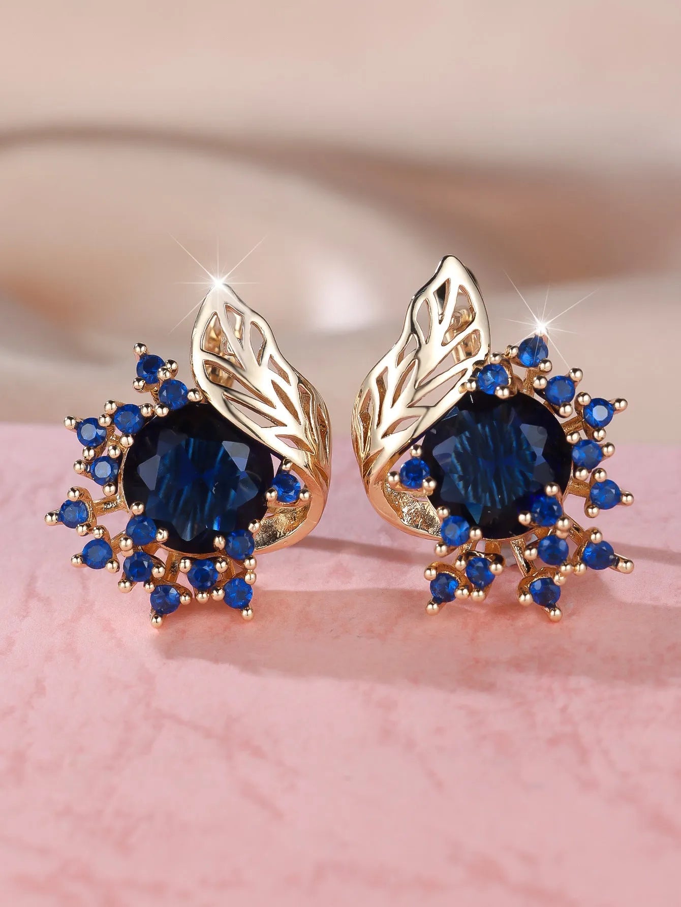 Round floral earrings with feather detailing and coloured zircon stones in champagne gold finish