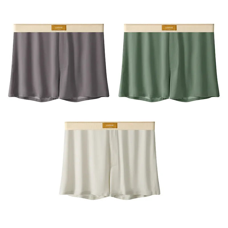 Pack of three men's solid colour loose fit ice silk underwear briefs on a grey background.