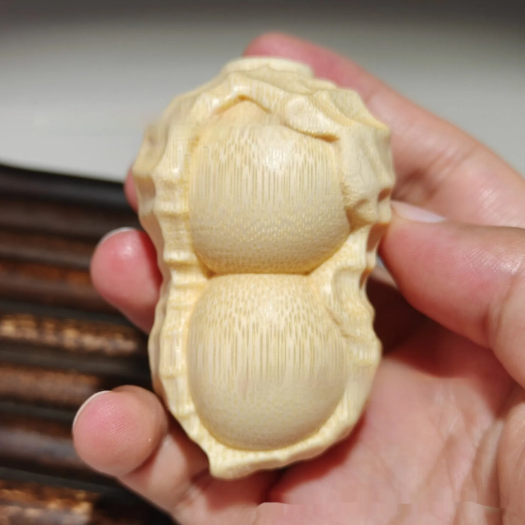 Solid bamboo carving peanut ornament with natural finish and modern simplicity design