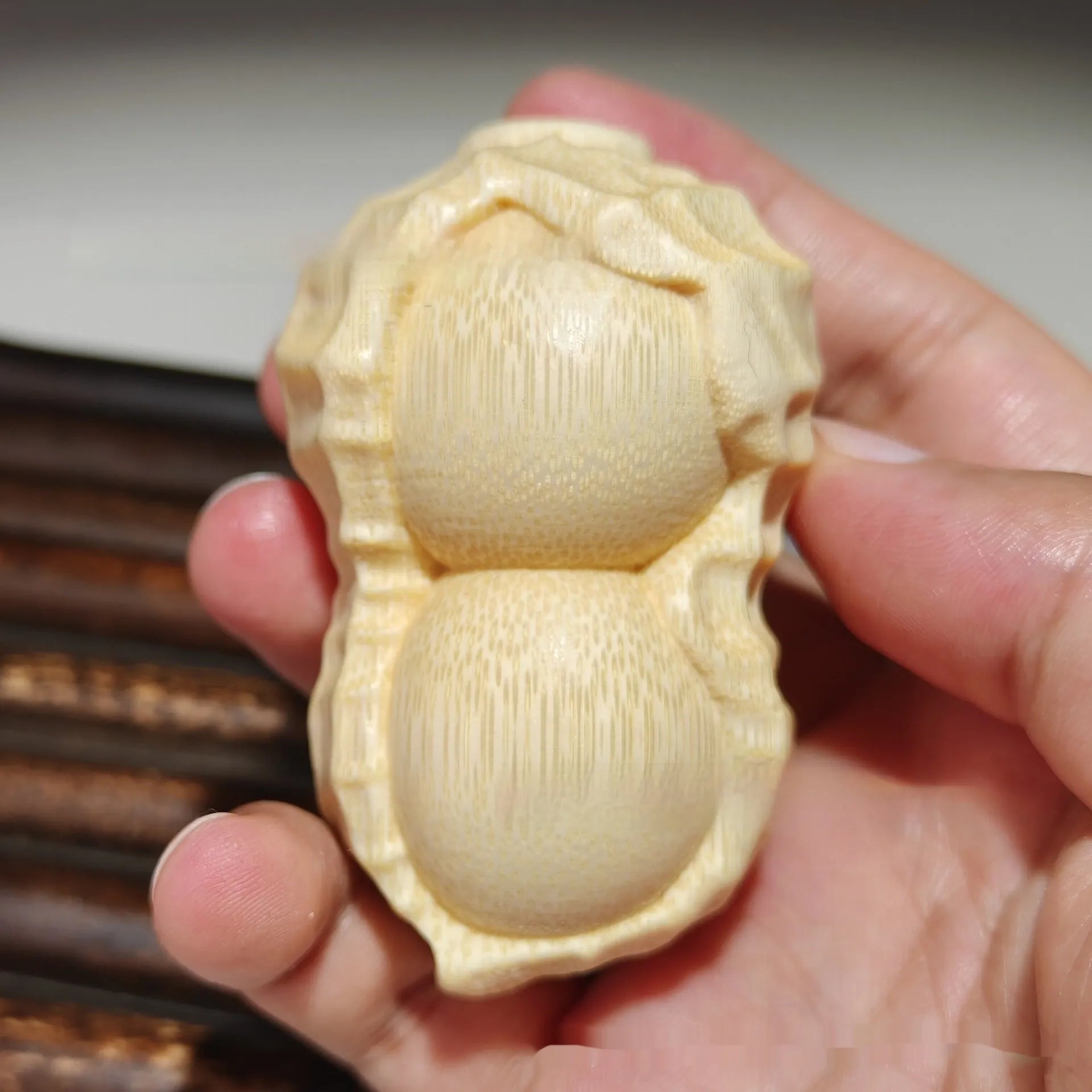 Solid bamboo carving peanut ornament with natural finish and modern simplicity design