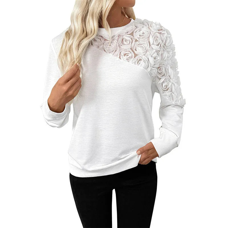 White floral pattern long sleeve pullover top on hanger showing loose fit design