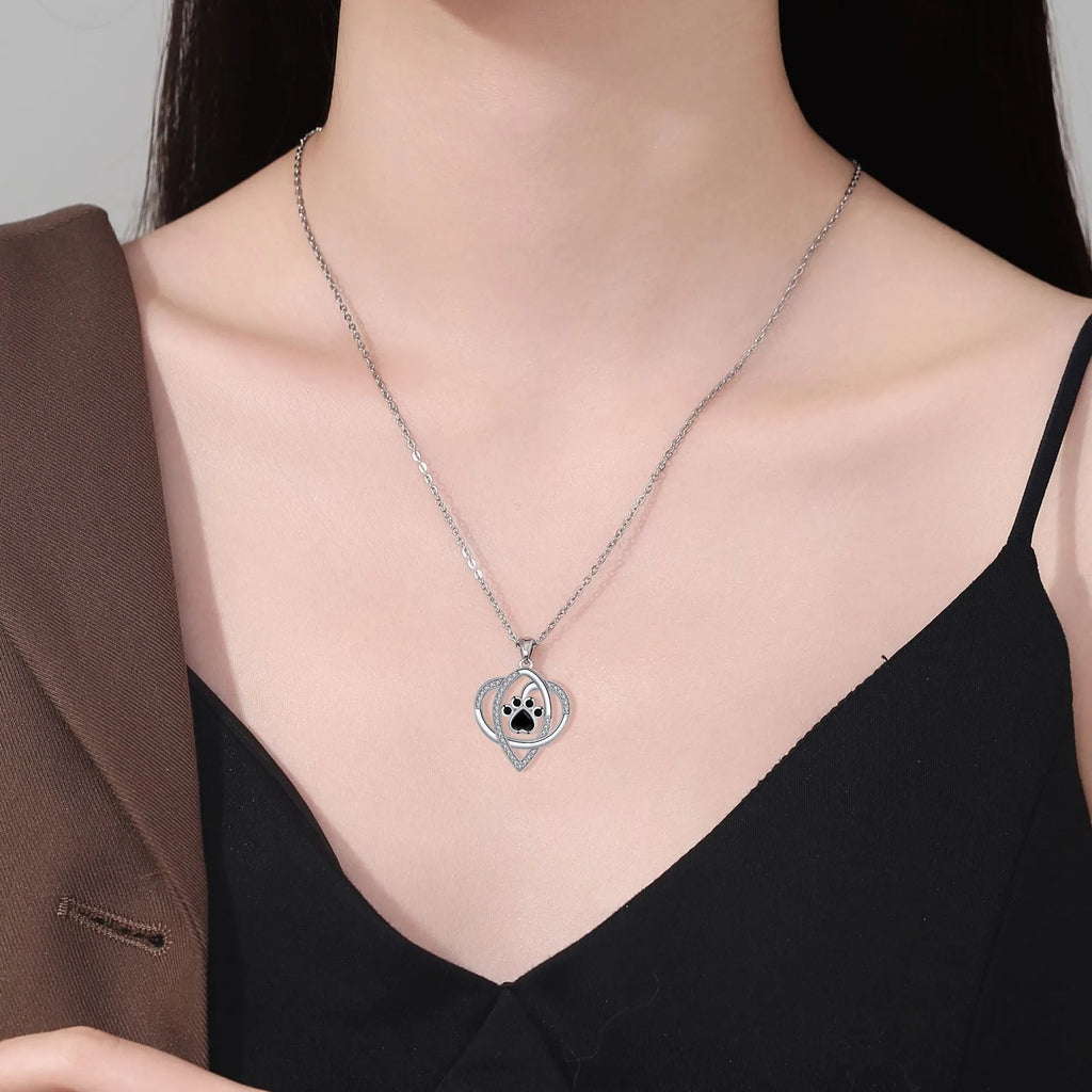 Copper pendant necklace with dog and cat paw print design on a cross chain