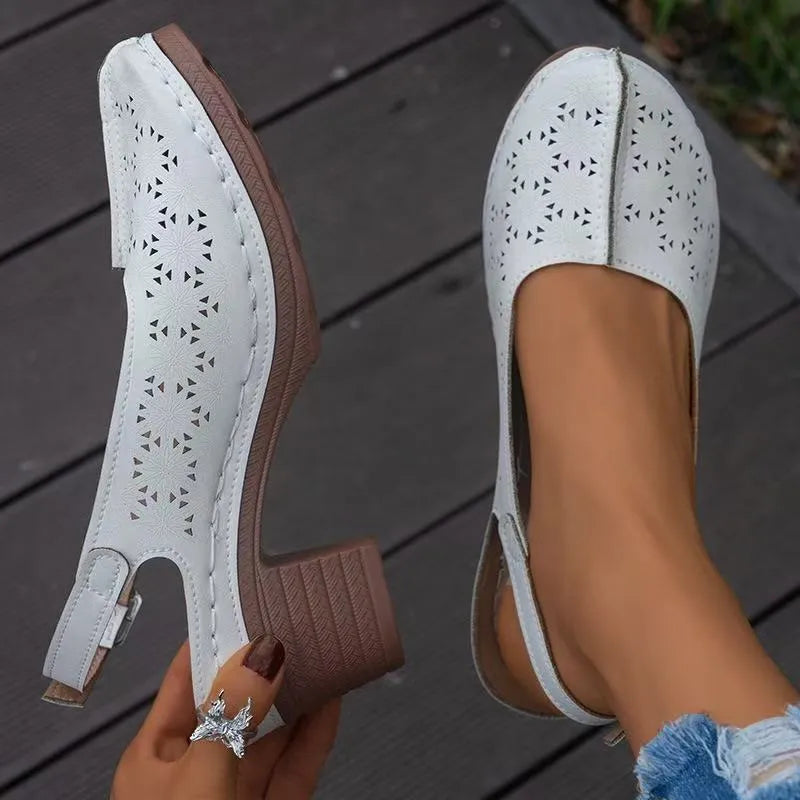 Women's closed toe wedge sandal in PU leather with a round toe and rubber wedge sole.