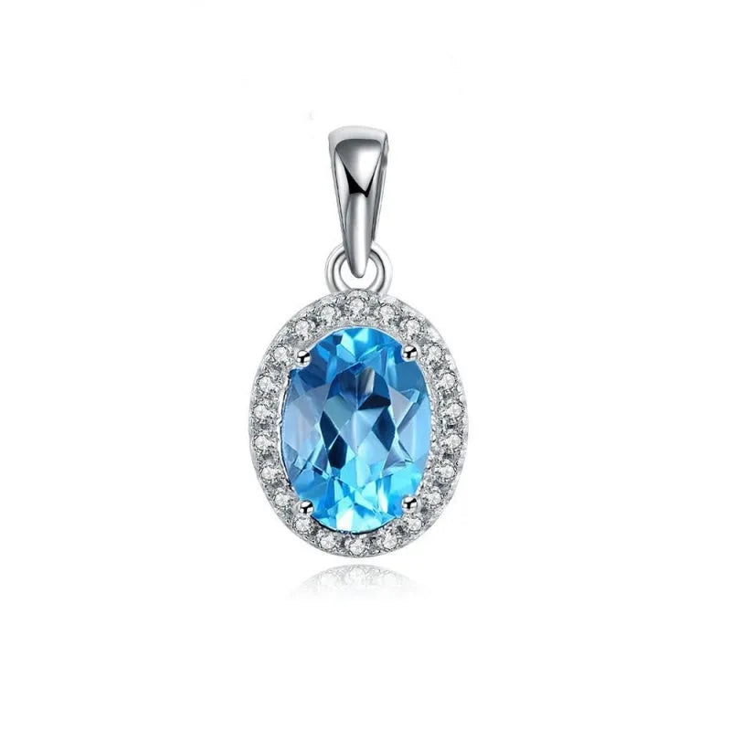Women's sterling silver jewellery set with blue topaz gemstones in geometric design including earrings, ring, pendant, and necklace