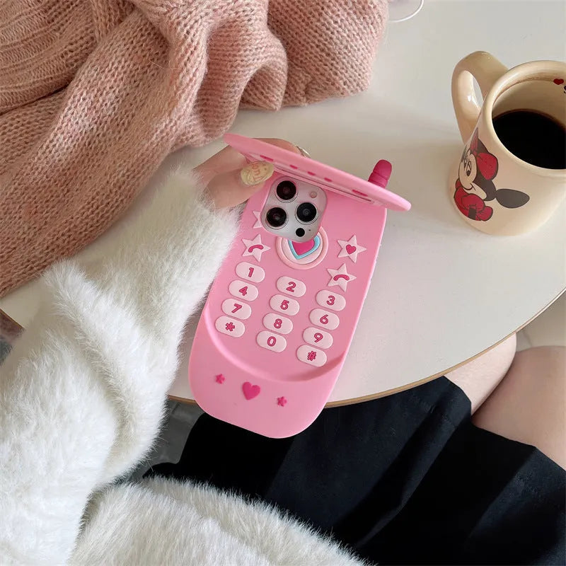 Light pink silicone flip phone case with mirror for iPhone, featuring a cute cartoon design.