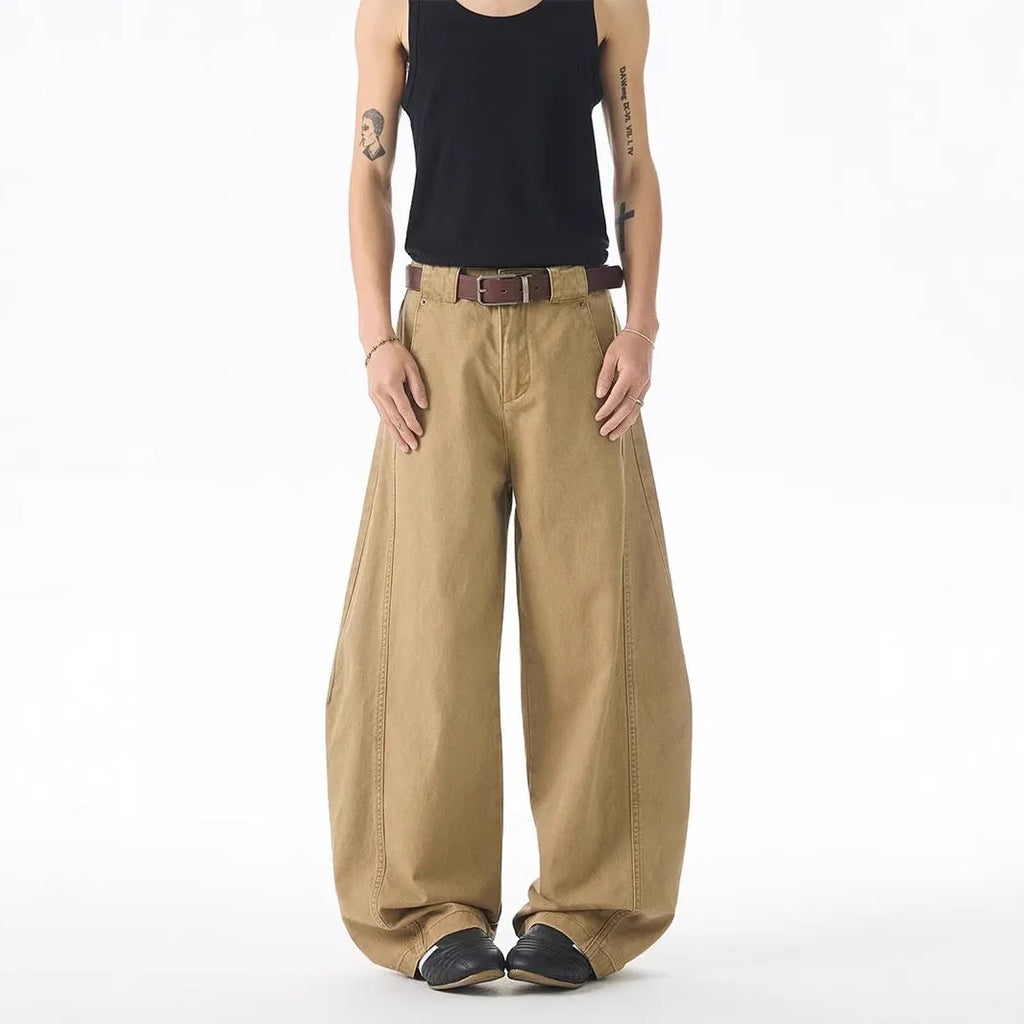 Brown men's loose-fit denim jeans with a straight leg and button fly on a neutral background.