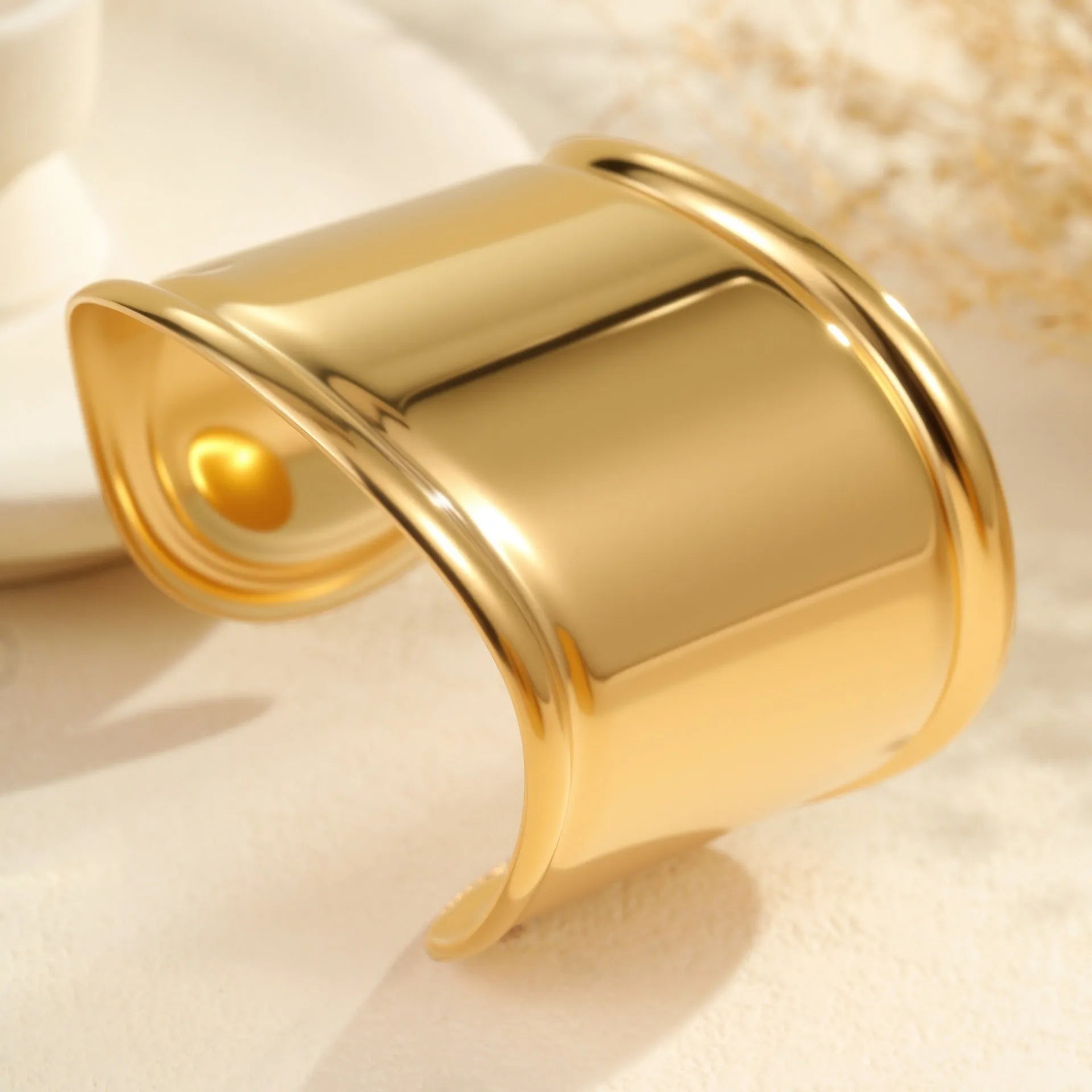 Gold plated stainless steel wide bracelet for women with geometric wave design and niche opening clasp
