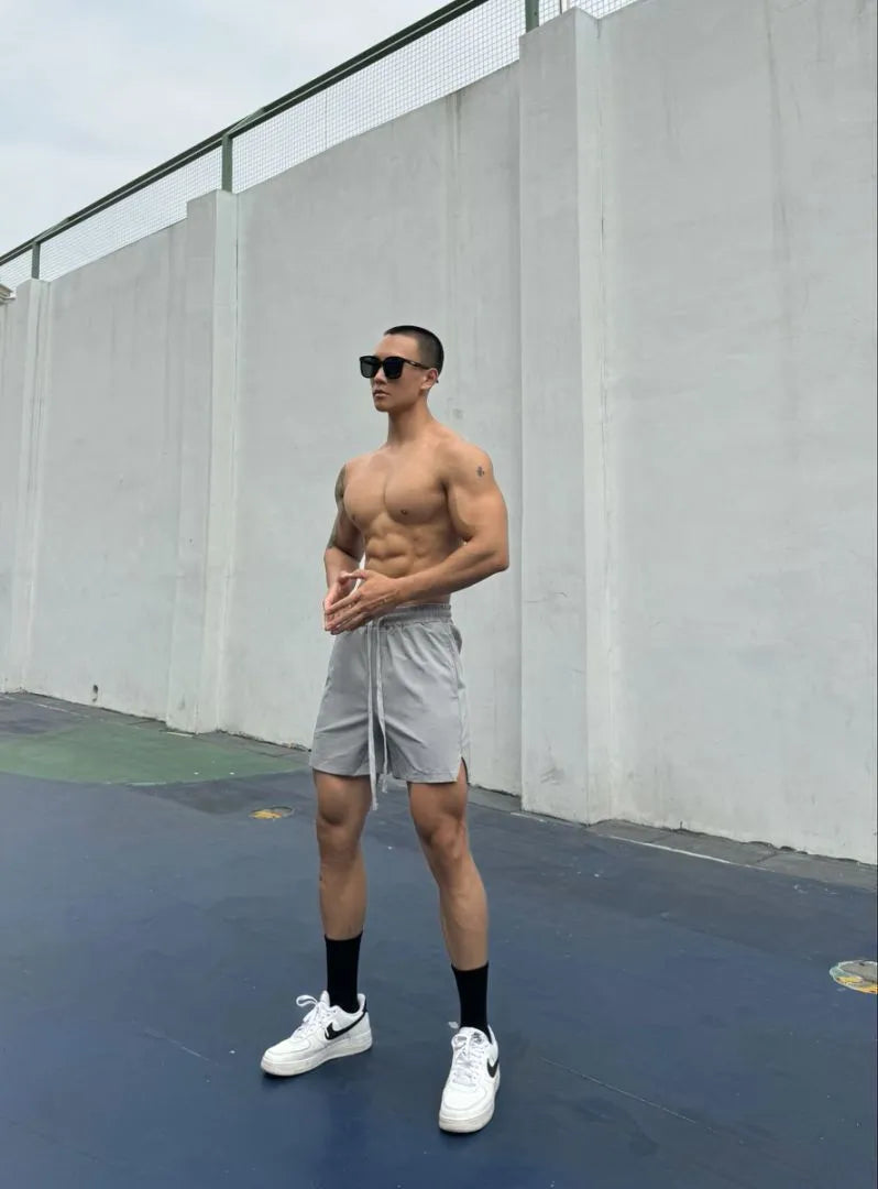 Man wearing grey ice silk quick-drying double-layer quarter shorts on a casual day out.
