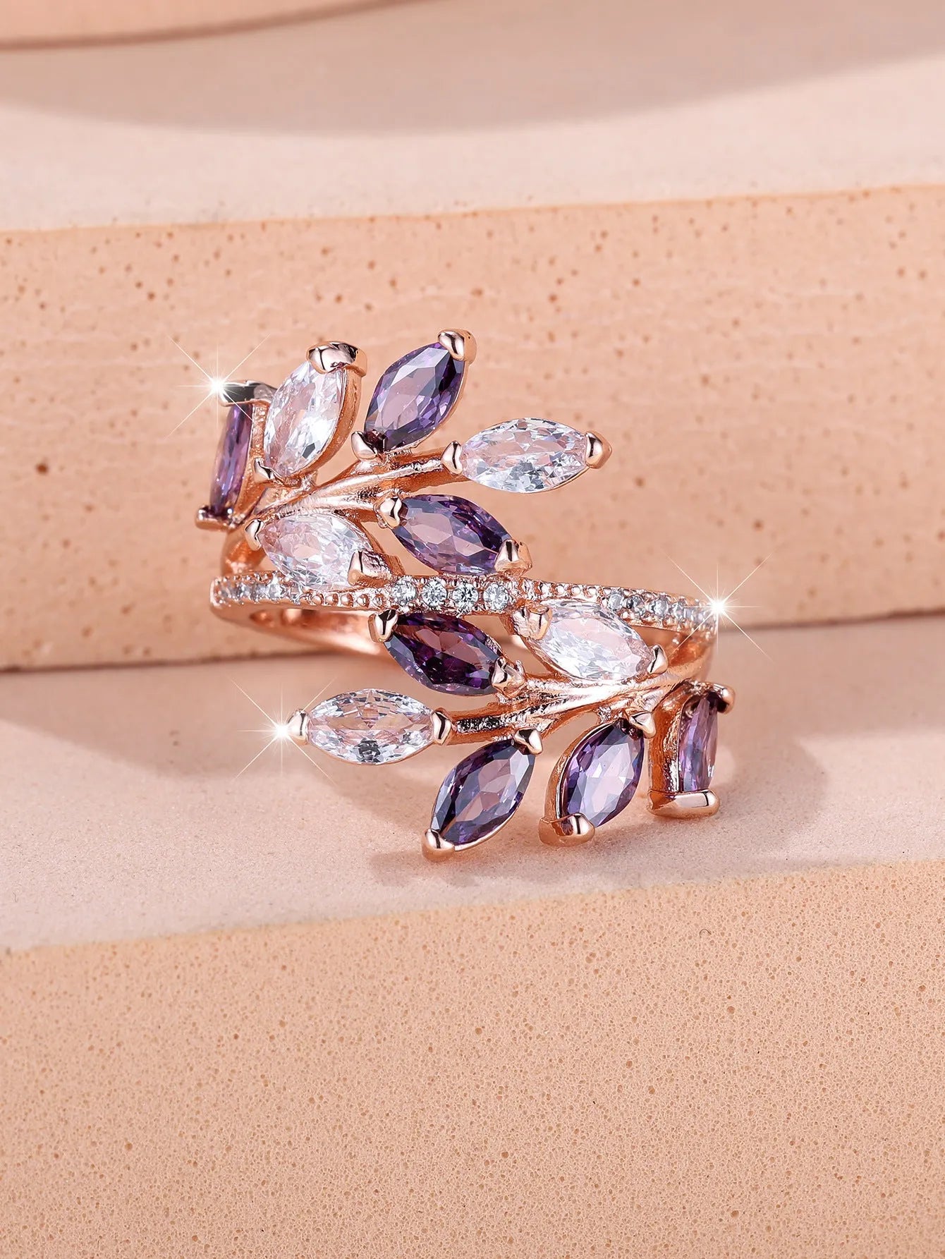 Adjustable horse eye zircon leaf ring in copper on a hand, showing leaf detail and colour options.