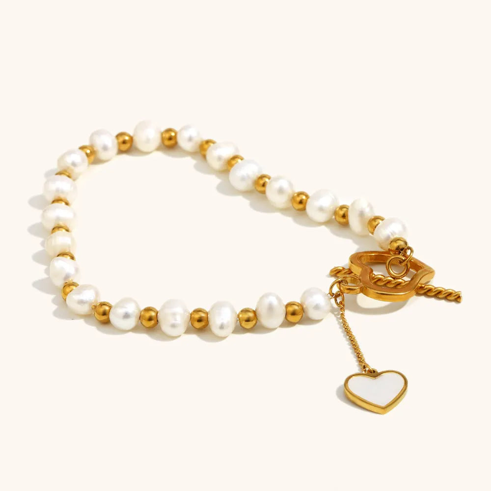 Gold pearl heart-shaped buckle bracelet on display