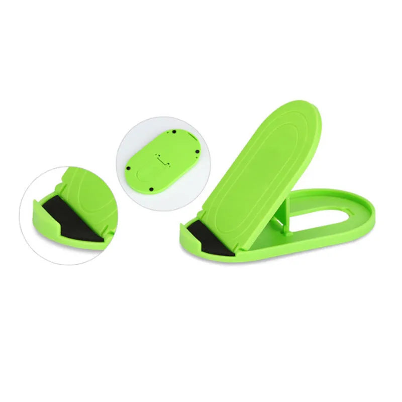 Plastic mobile phone stand with adjustable bracket in six colour options on a wooden desk