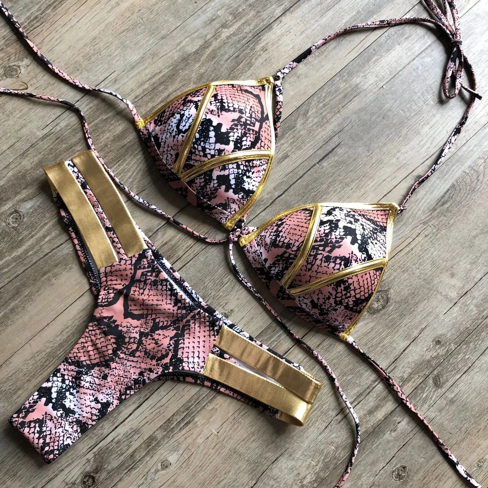 Women's bronzing bikini swimwear with chest pads in various colours and prints.