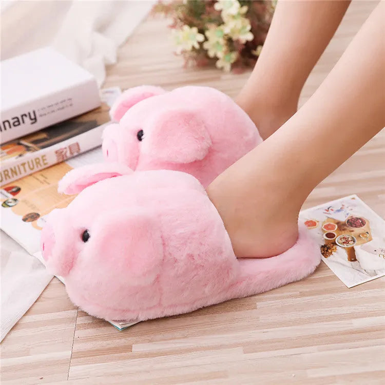 Pink plush pig slippers for adults with soft short fur and PP cotton filling on a white background.