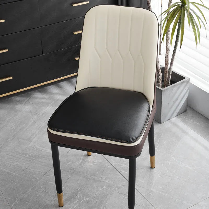 Leather horseshoe-shaped non-slip seat cushion in a solid colour on a chair.