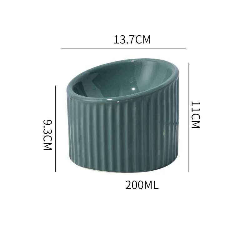 A dark green round ceramic cat bowl elevated on a base, shown at an angle.