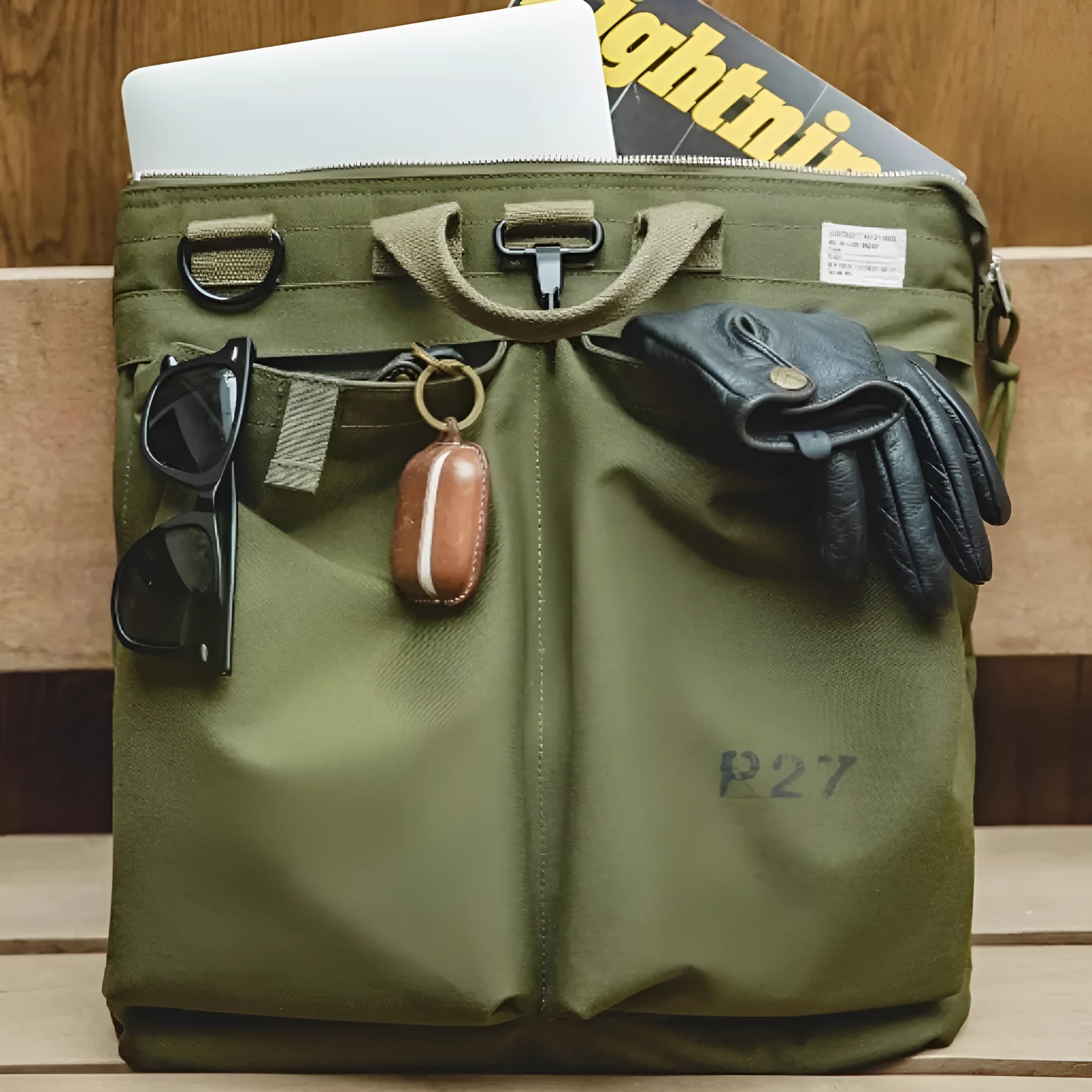 Canvas crossbody shoulder bag in military green with phone pocket and space for 15-inch laptop