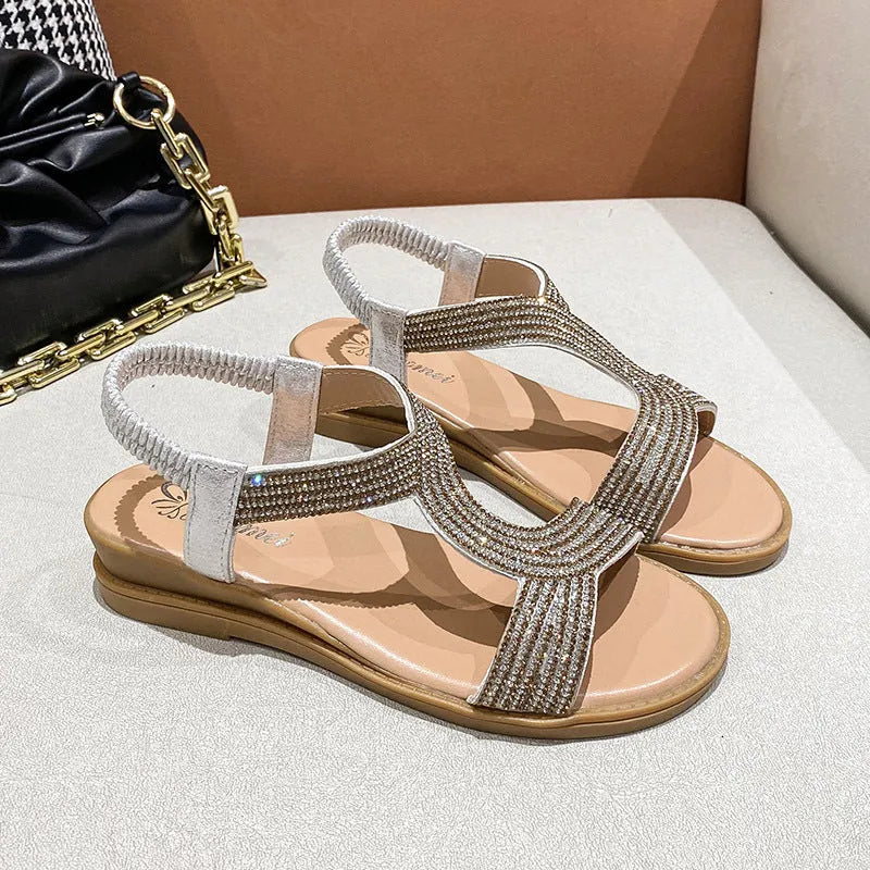 Women's patent leather summer sandals with rhinestone detail on round toe, shown in gold colour