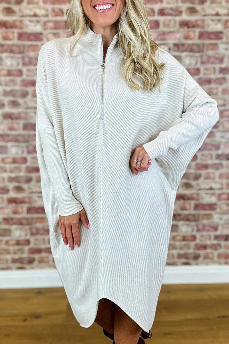 Women's solid colour loose fit knitted dress with raglan sleeves on a model.